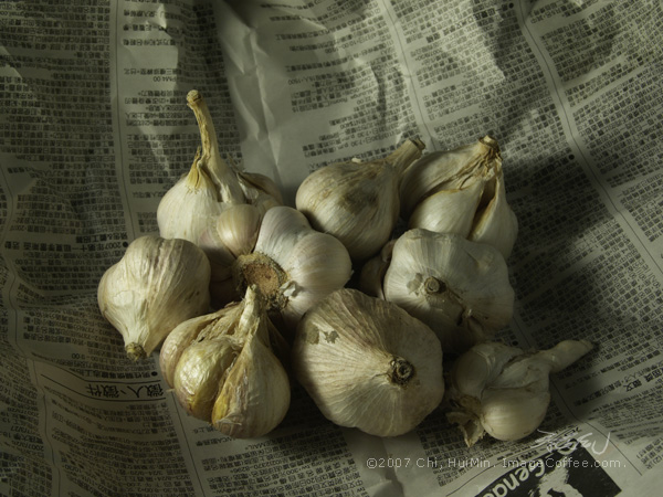 Garlic Bulbs On Newspaper
