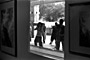 Practice makes perfect: <br/>Those young students were dancing outside a gallery. They used the glass as the mirror in order to look themselves. 